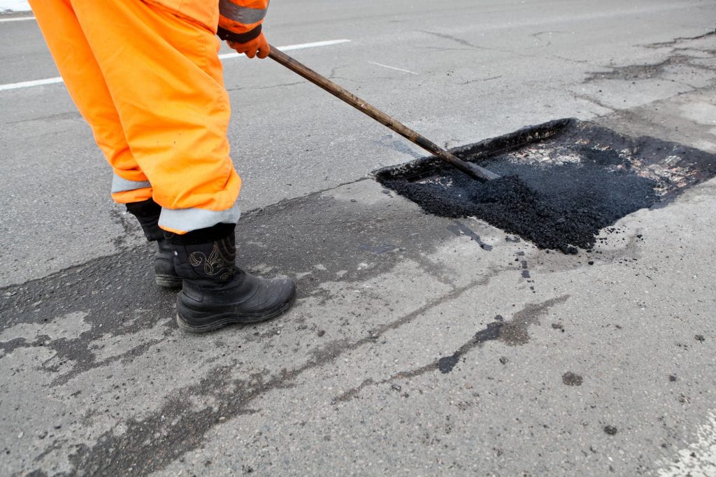 Street resurfacing. Fresh asphalt construction. Bad road